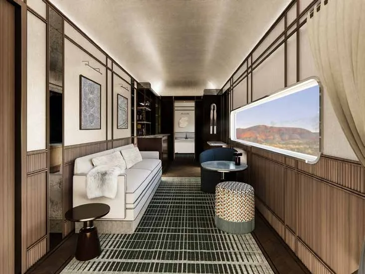 Aurora Suite - salon panoramique avec tapis vert et vue sur les paysages australiens depuis le train de luxe Journey Beyond
